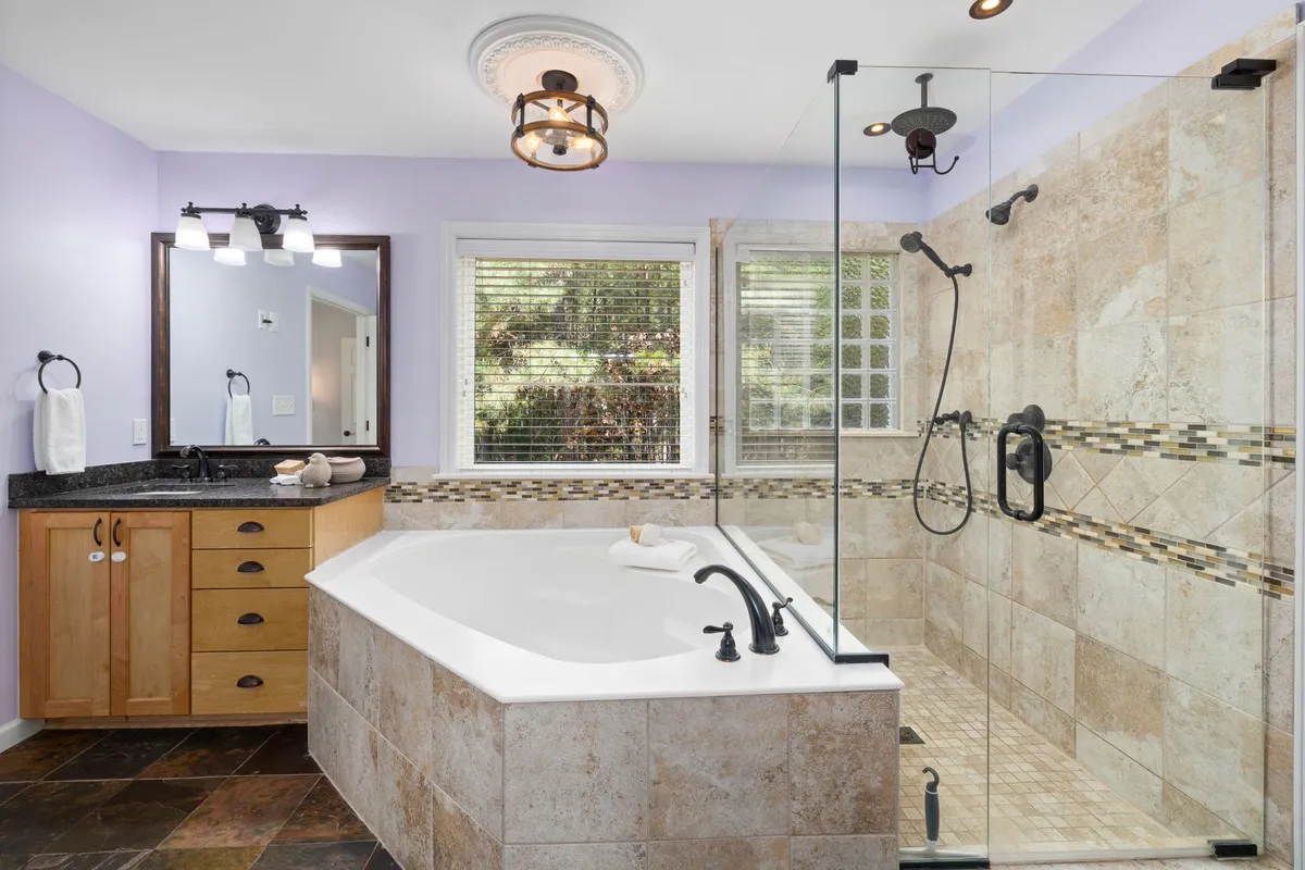 Spa-inspired bathroom with rainfall shower and natural stone surfaces