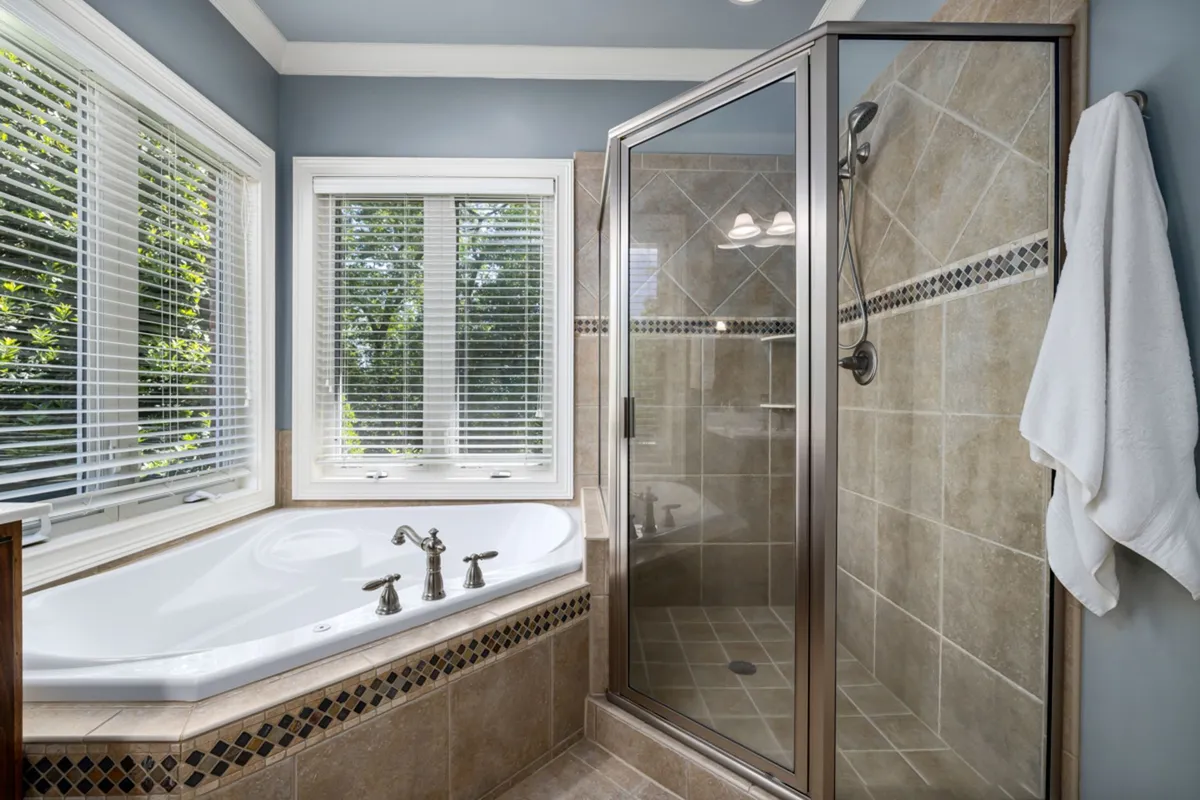 Luxurious spa bathroom detail showing natural materials and ambient lighting