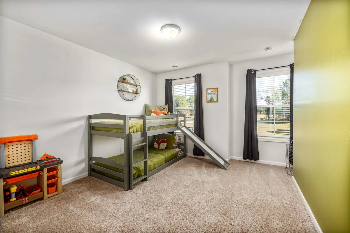 Teen bedroom with gallery wall, desk setup, and comfortable reading chair