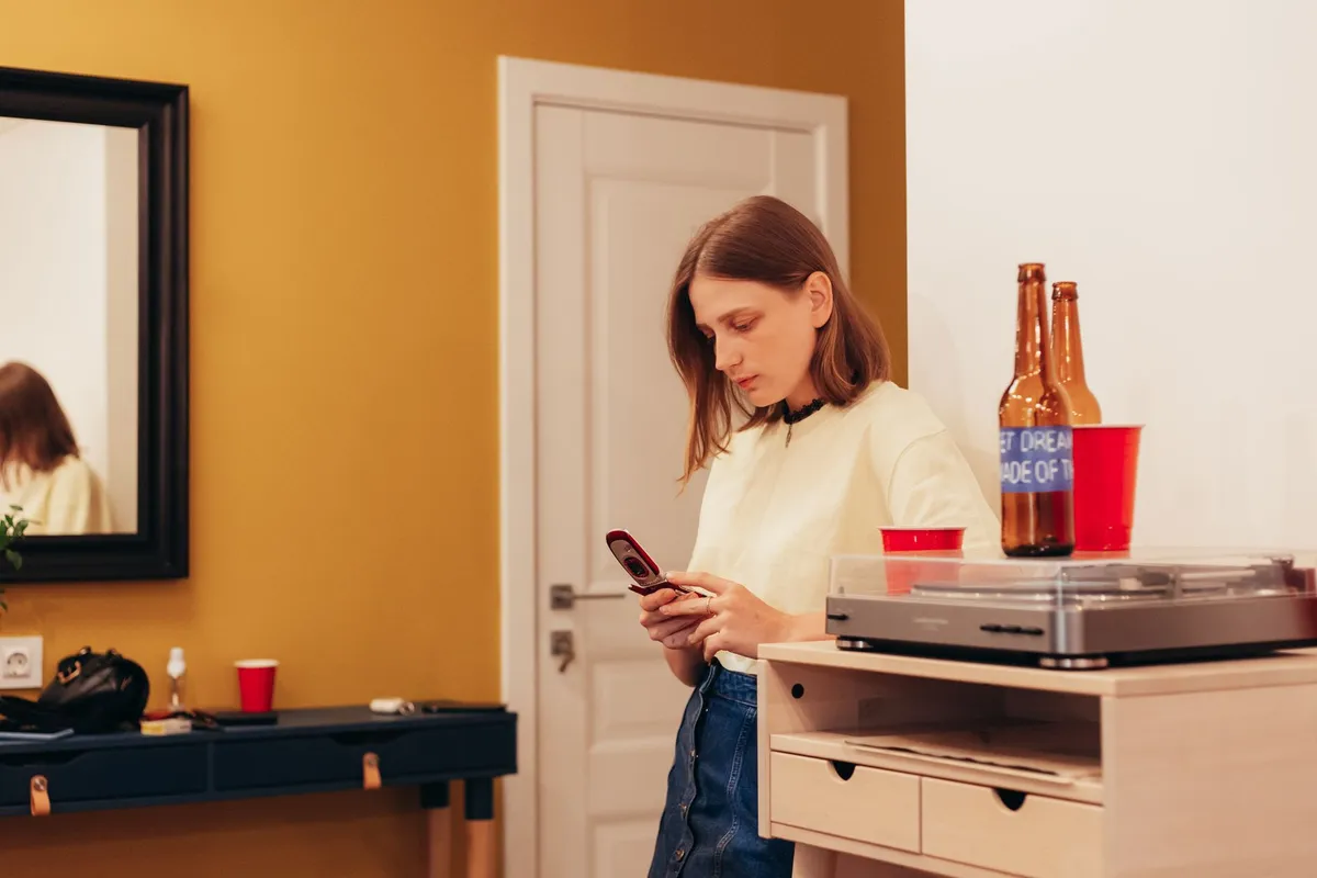 Person using AI room design tool on laptop to visualize interior changes