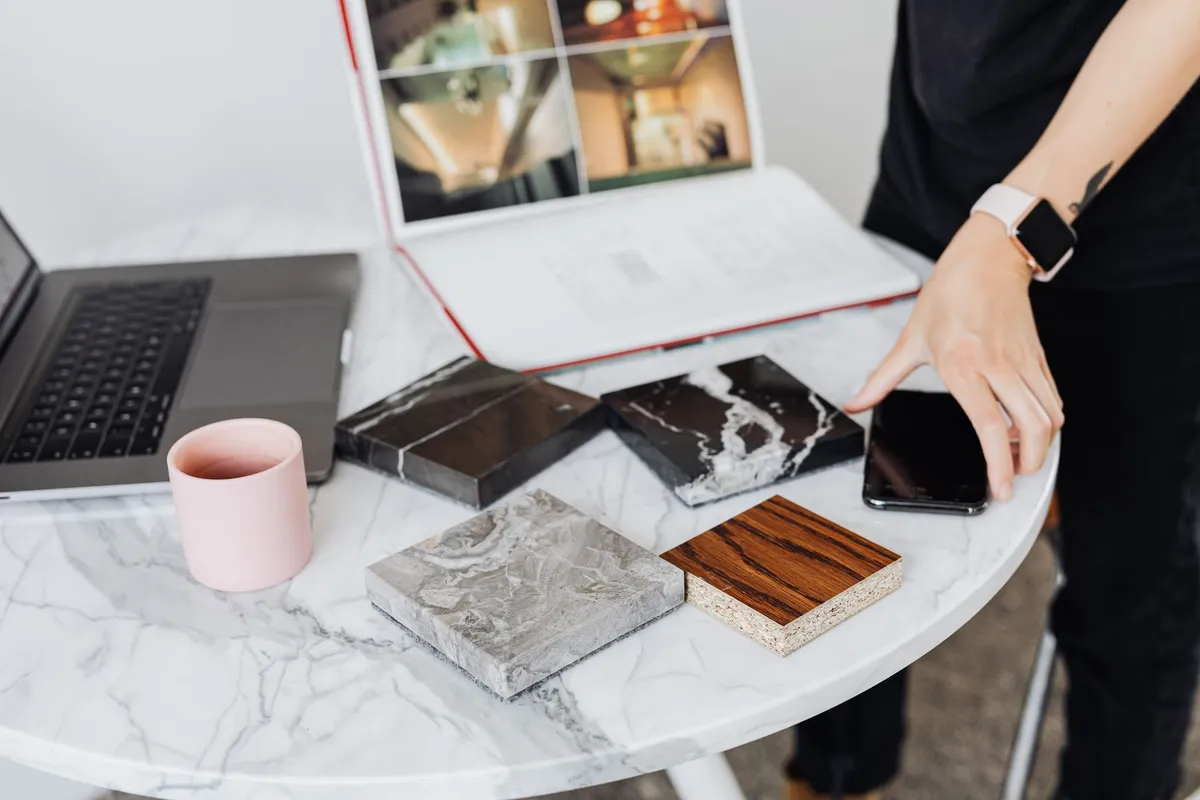 Interior designer reviewing design samples and floor plans with homeowner