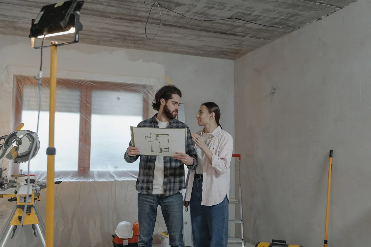 Budget planning for home renovation with laptop and cost comparison notes
