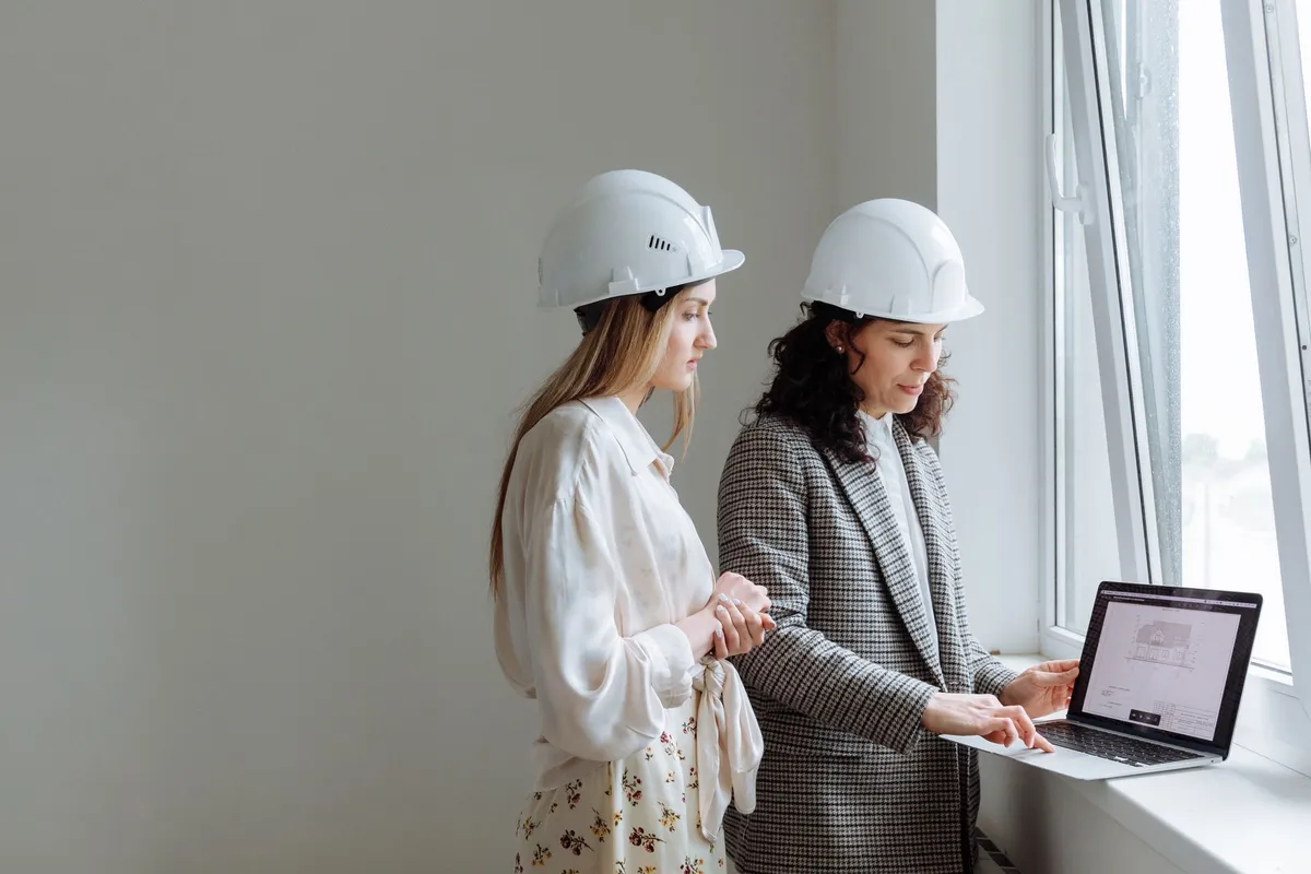 Professional interior designer reviewing material samples and presenting design board to clients