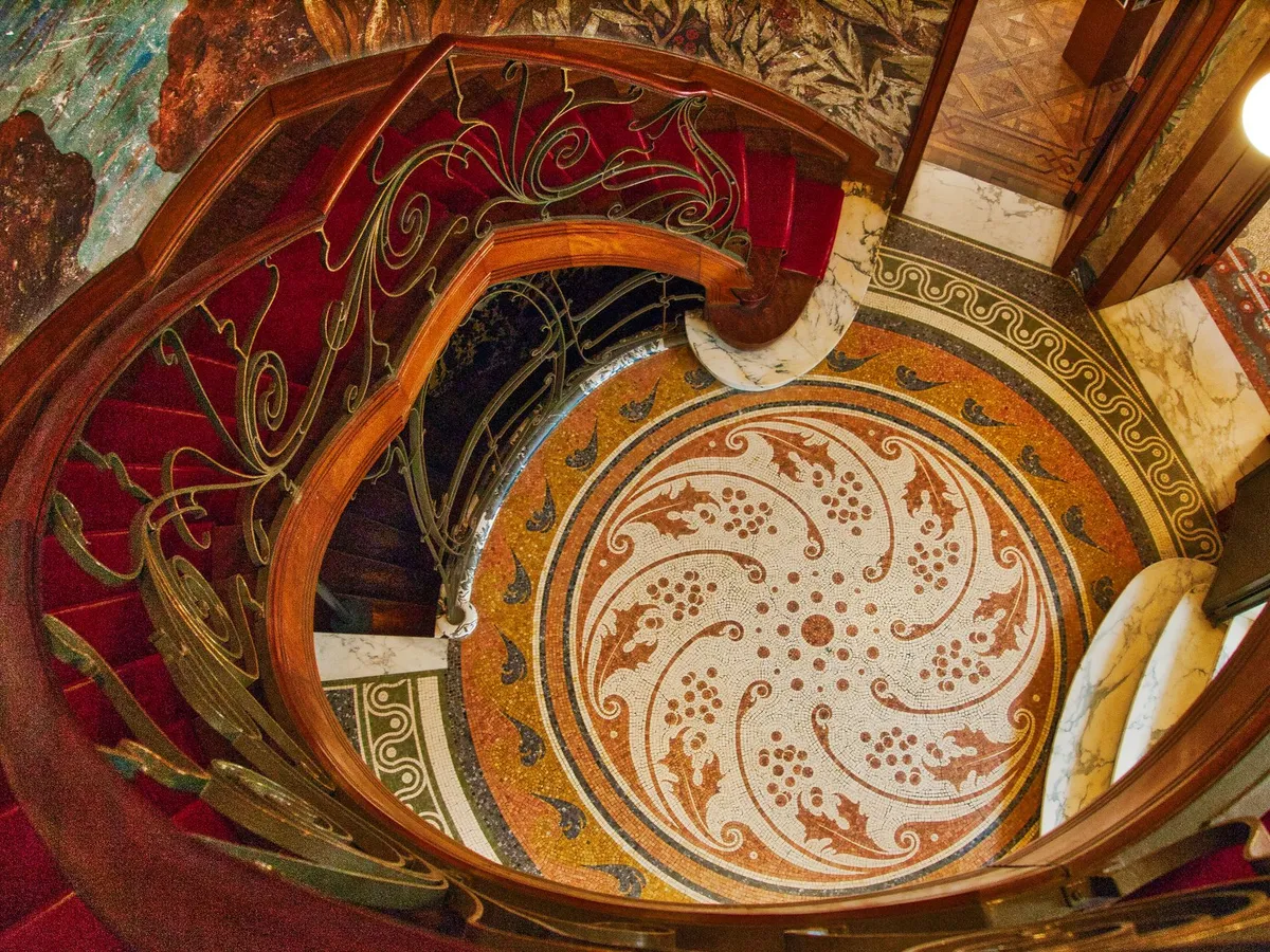 Art Nouveau inspired furniture with organic carved details and botanical upholstery pattern