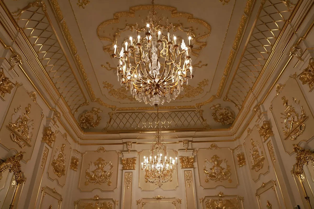 Baroque interior design with ornate gold accents, rich velvet upholstery and dramatic architectural ceiling details