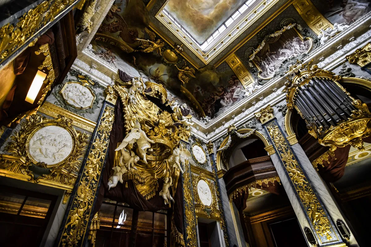 Modern baroque interior showing gilt mirror, velvet furniture and rich jewel-tone color palette in a contemporary home
