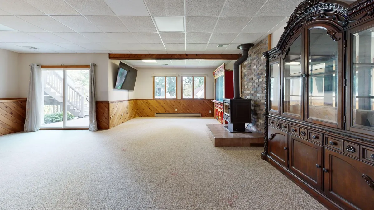 Finished basement living space with modern finishes, comfortable seating and recessed lighting