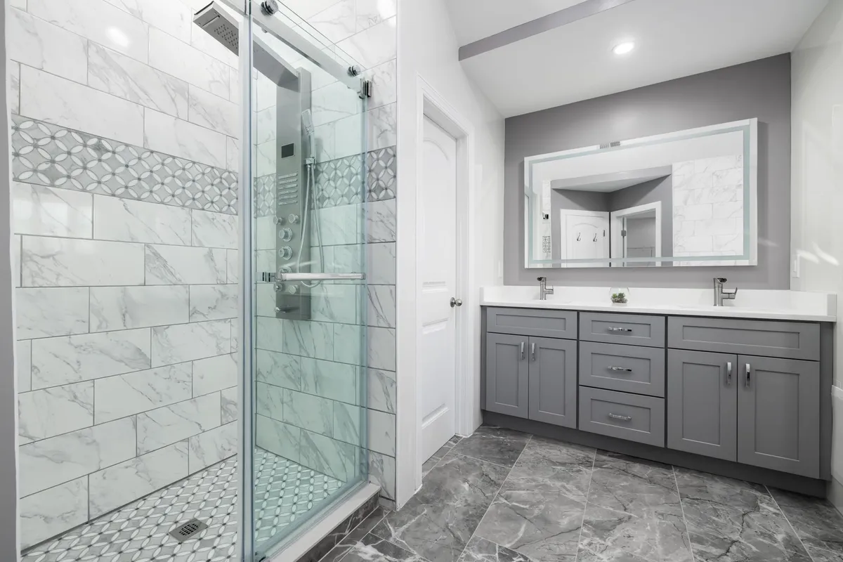 Bathroom vanity detail with brushed brass fixtures and marble countertop