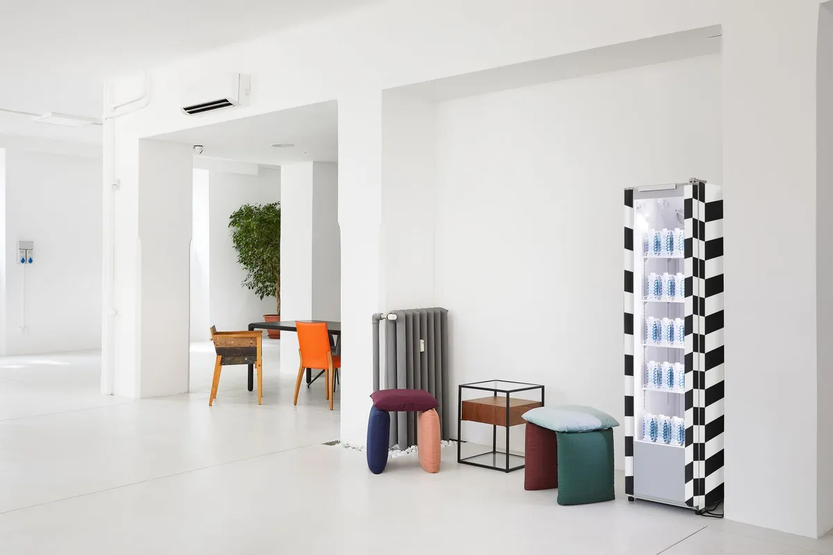 Marcel Breuer-style tubular steel cantilever chair beside a geometric side table in a minimalist study