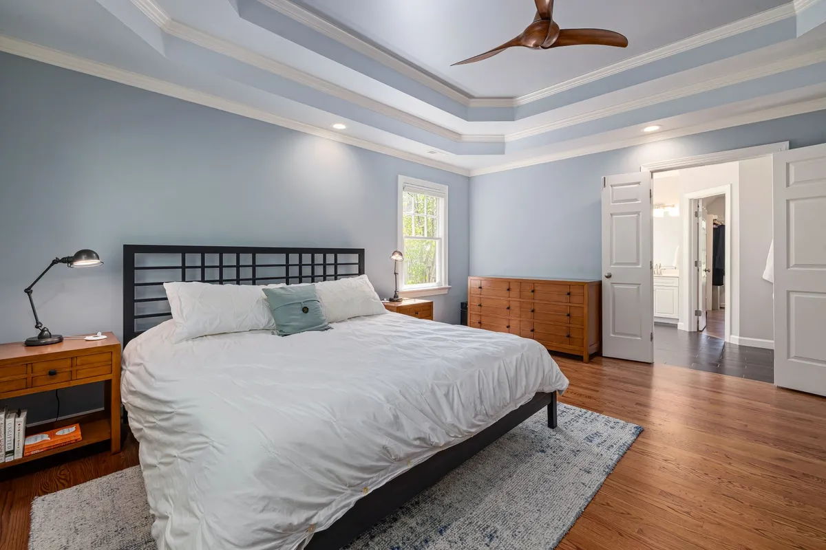 Renovated bedroom sanctuary with optimized furniture layout and soft neutral tones