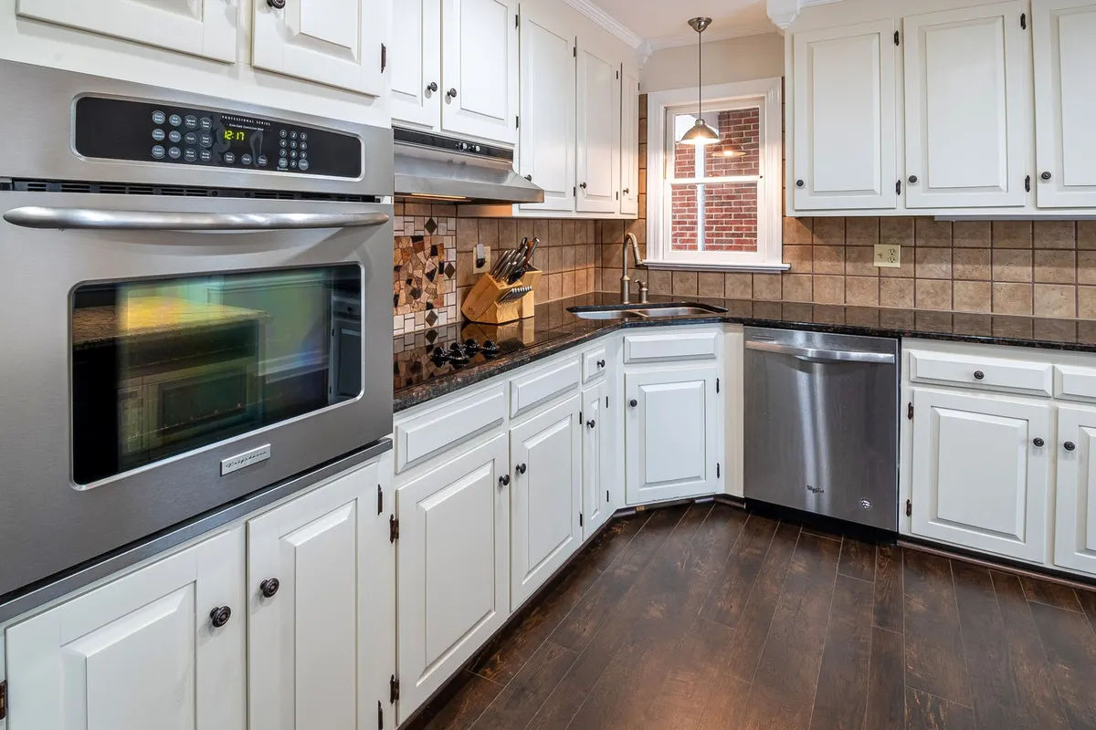 Modern white and black kitchen transformation with quartz countertops and open shelving