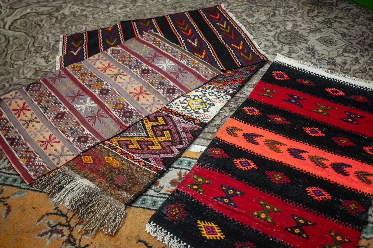 Bohemian living room with layered textiles, terracotta tones, and macramé wall art