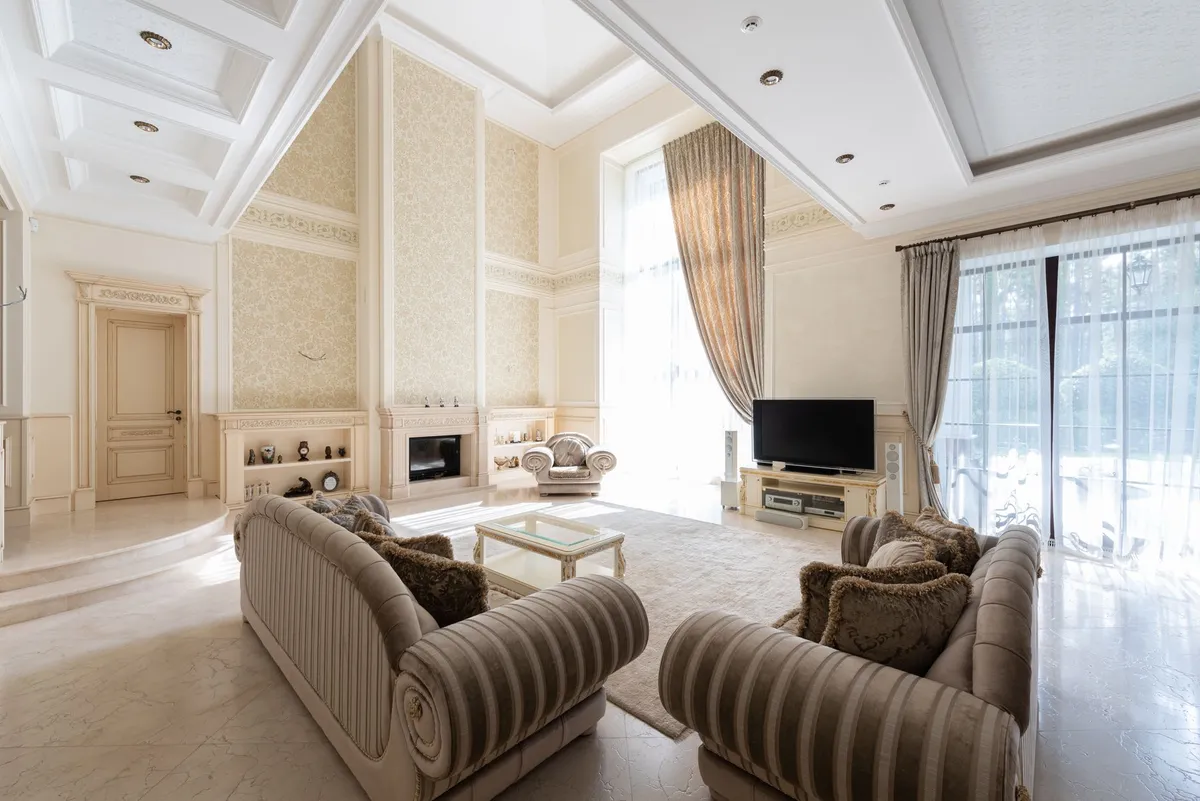 Luxury bedroom with layered linen and velvet textiles, brass lighting, and natural stone detail