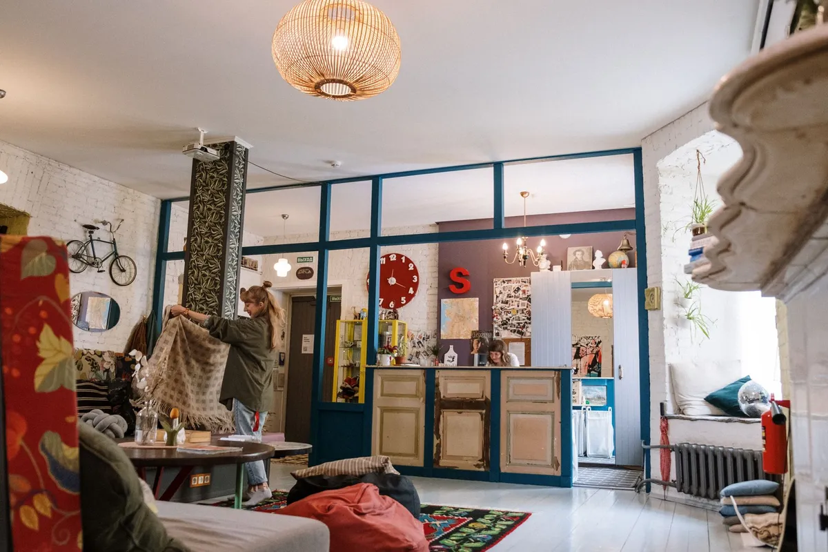 Eclectic living room with mixed furniture styles Persian rug vintage chair and modern sofa
