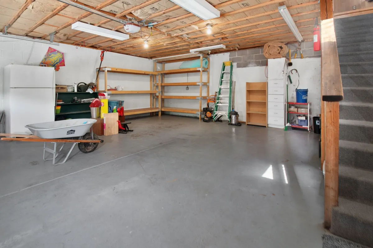 Converted garage home gym with rubber flooring, mirrors, and organized equipment