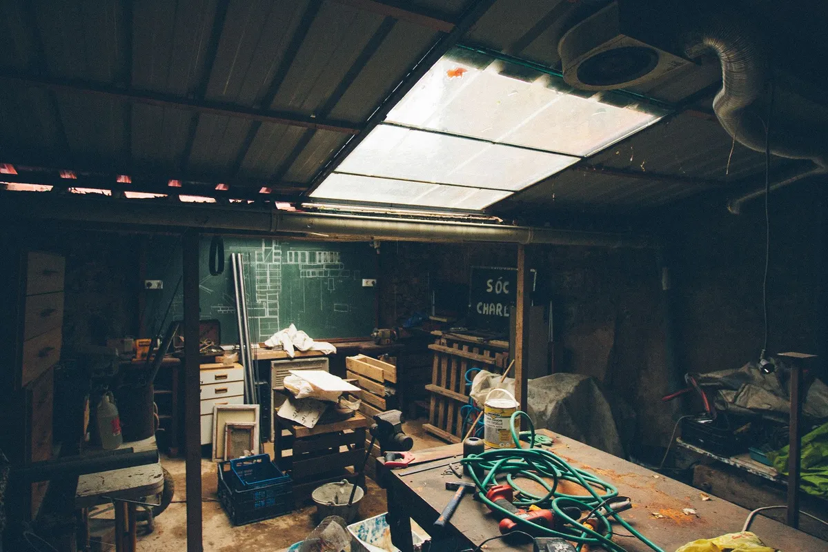 Renovated garage converted to bright home studio with epoxy floor and organized storage