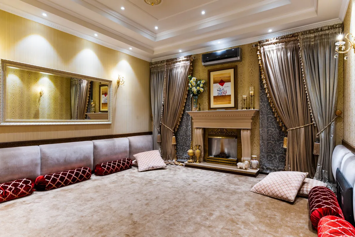 Hollywood Regency glam living room with velvet sofa, gold accents, and mirrored furniture