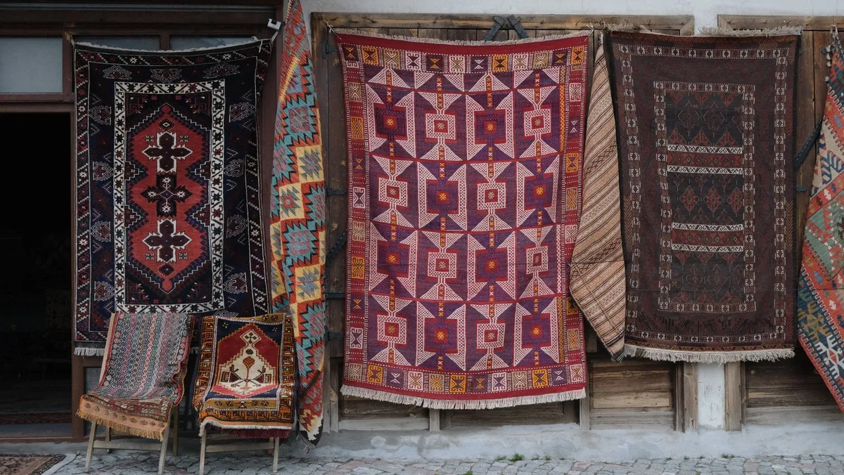Global bohemian living room with layered textiles, woven baskets, and worldly decorative objects