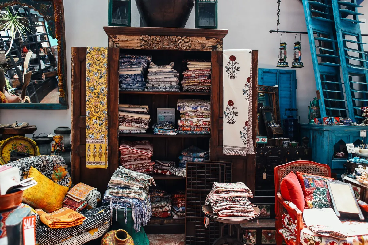 Global bohemian bedroom with layered textiles, pattern mixing, and cultural artifacts