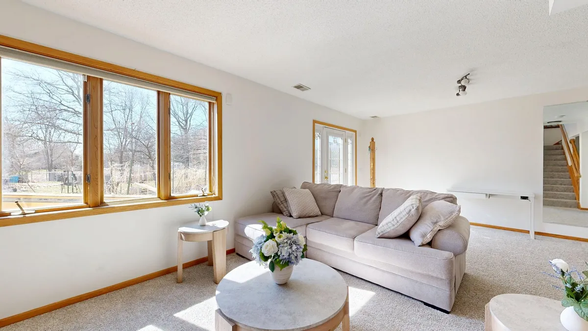 Well-staged dining room and living area with coordinated neutral decor