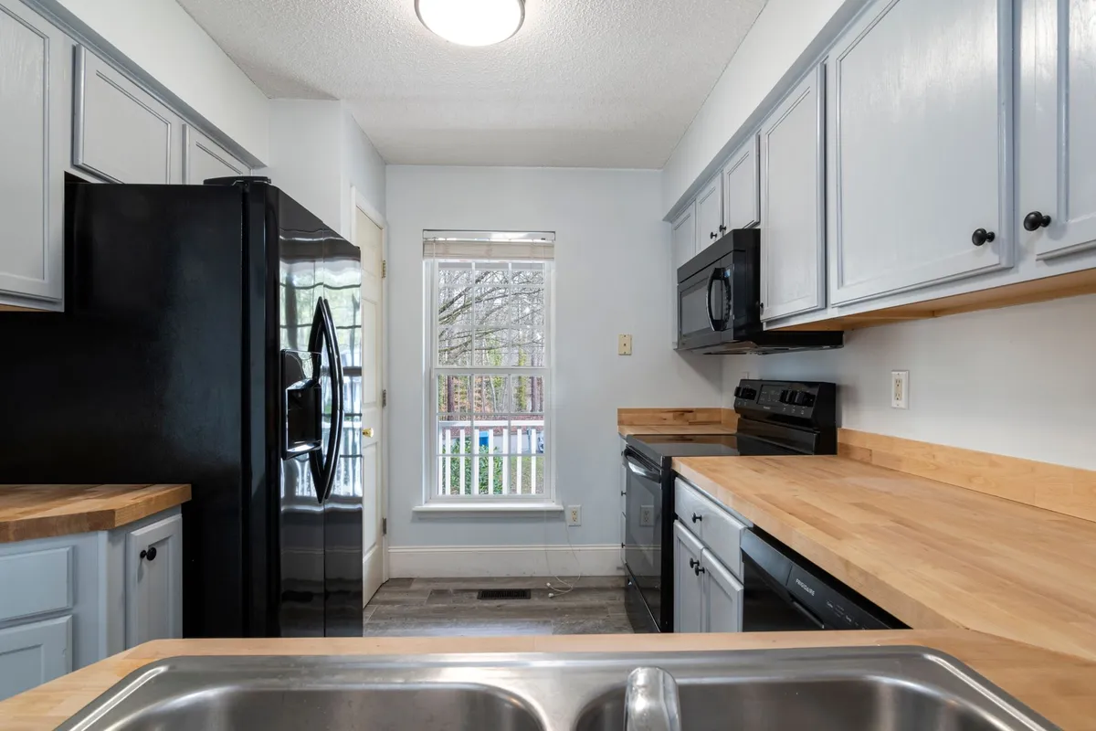 Kitchen backsplash tile installation with subway tile and fresh painted cabinets