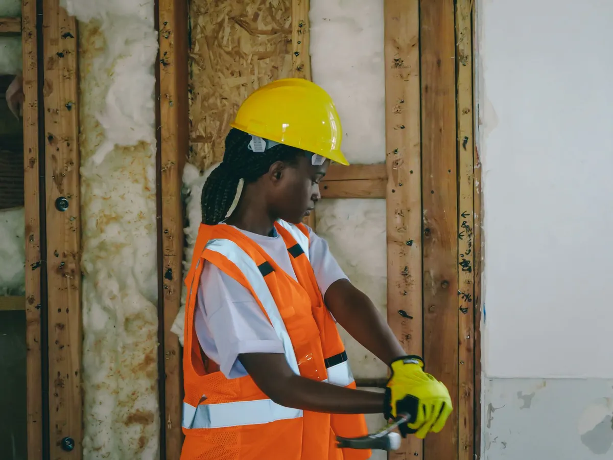 Contractor reviewing renovation progress with homeowner using tablet showing design reference images