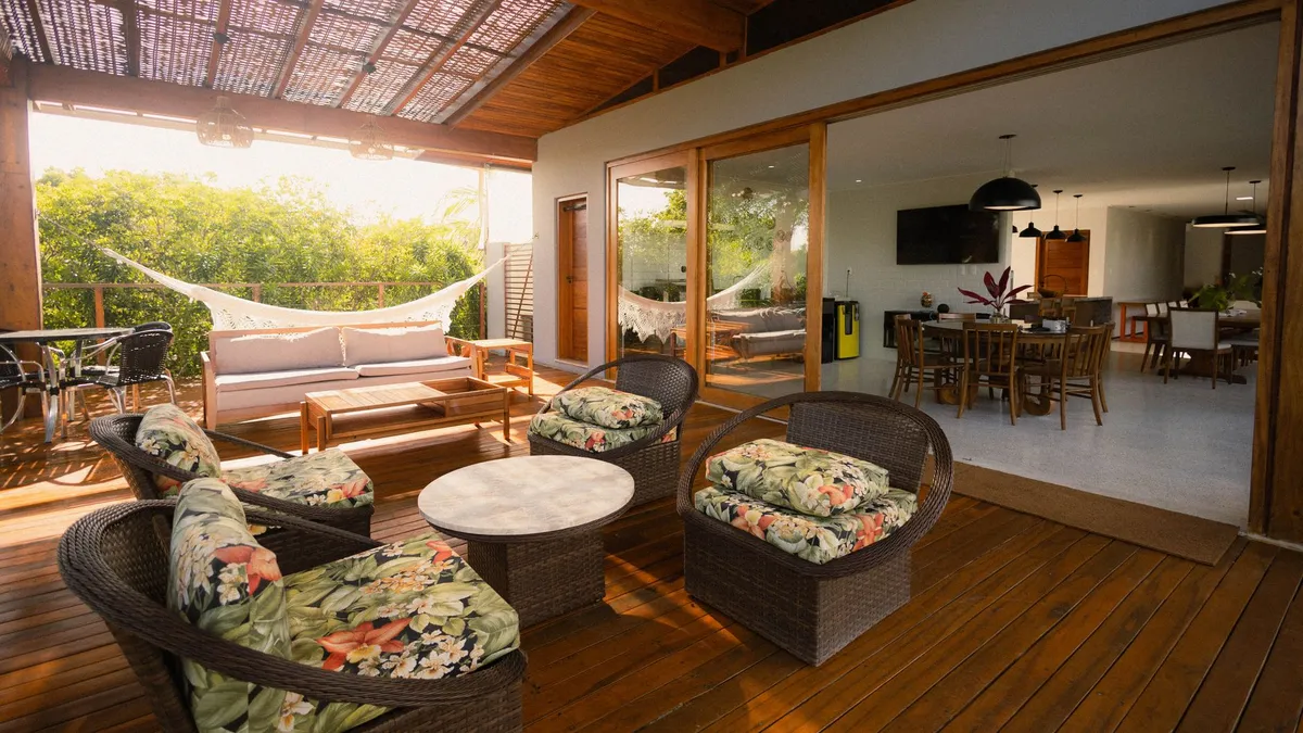Outdoor kitchen with built-in grill and dining area connected to interior