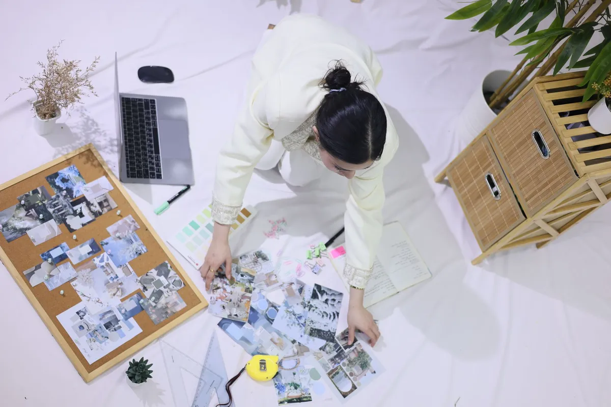 Interior designer reviewing room design renders on tablet during client meeting