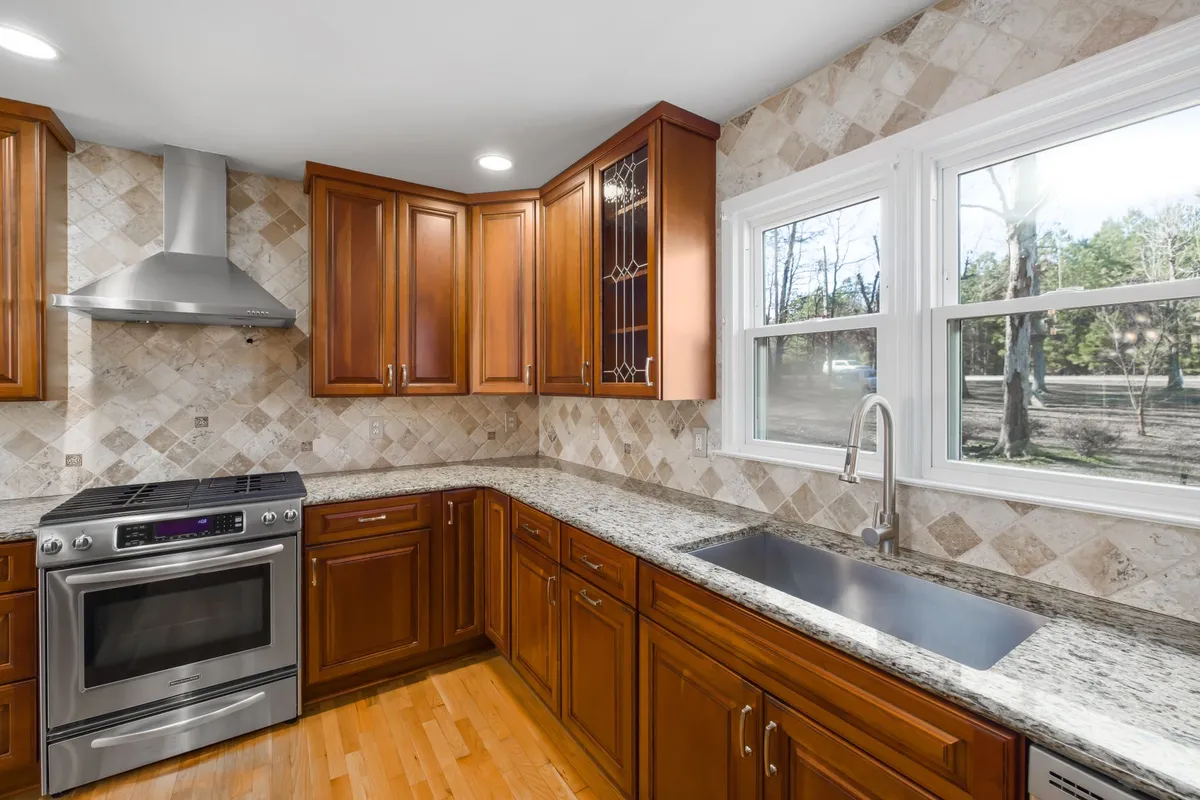 Kitchen under renovation showing new cabinet boxes installed with countertop templates in place