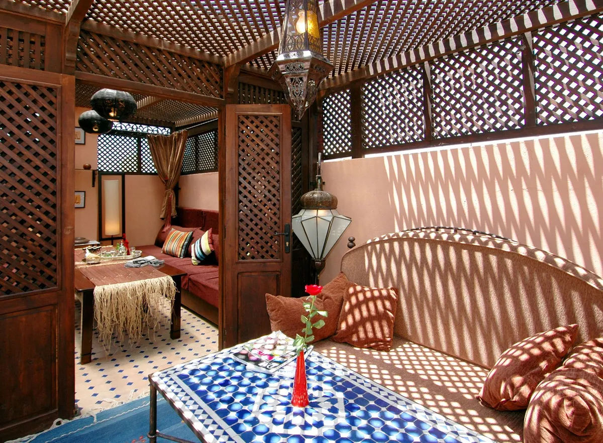 Moroccan interior design with colorful zellige tiles, ornate lanterns and rich textile patterns in a living space
