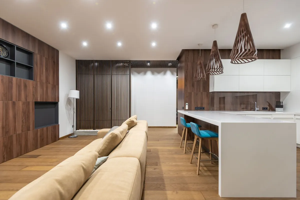 Open plan dining kitchen with waterfall island quartz countertop and integrated dining seating
