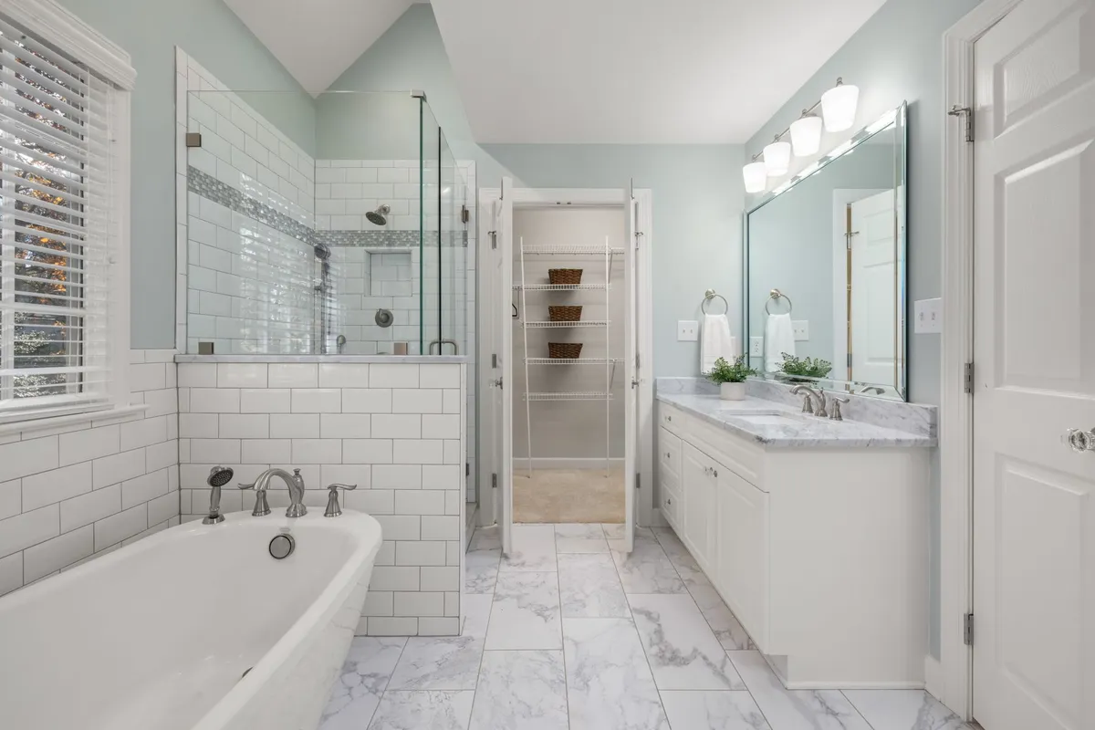 Before and after bathroom renovation with new tile, fixtures, and updated design