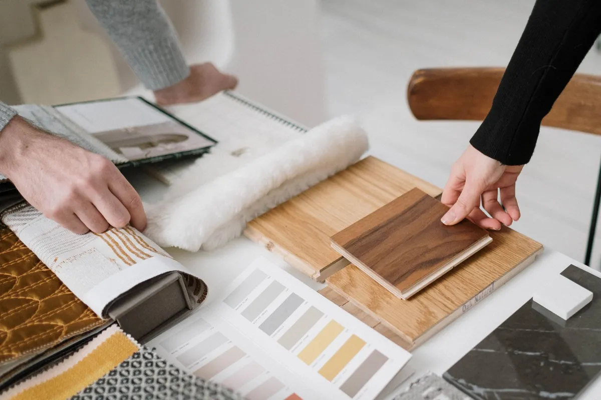 Homeowner using AI design tool on laptop to compare room styles before renovation