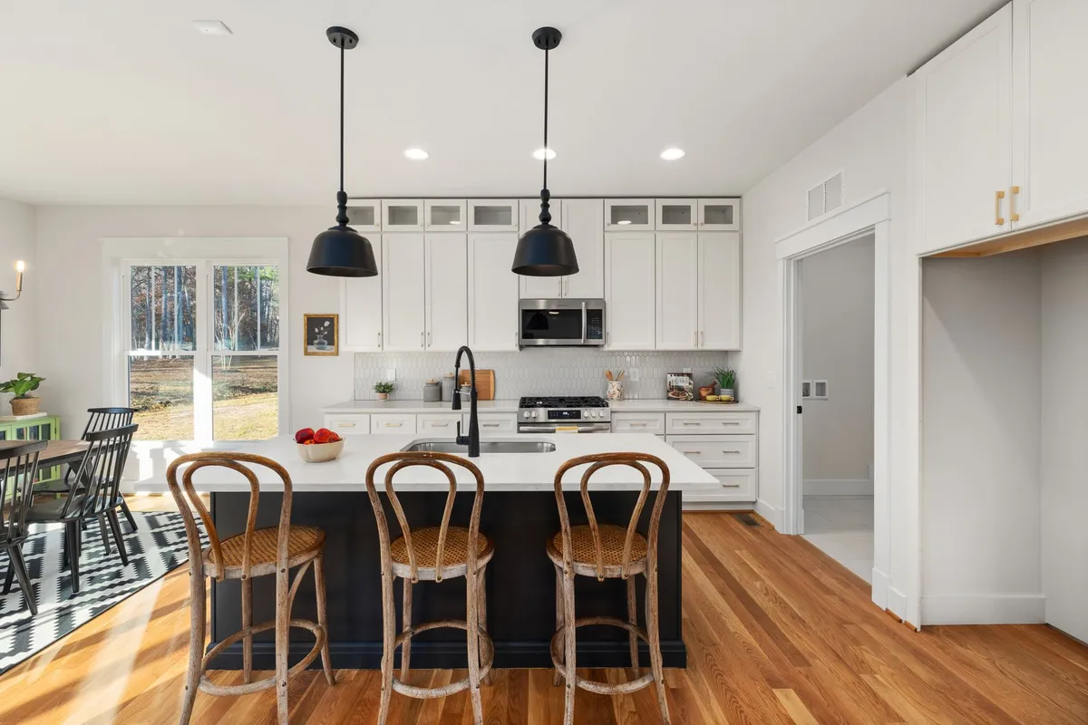 Rustic contemporary kitchen featuring reclaimed wood shelving, stone countertops, and clean-lined contemporary cabinetry