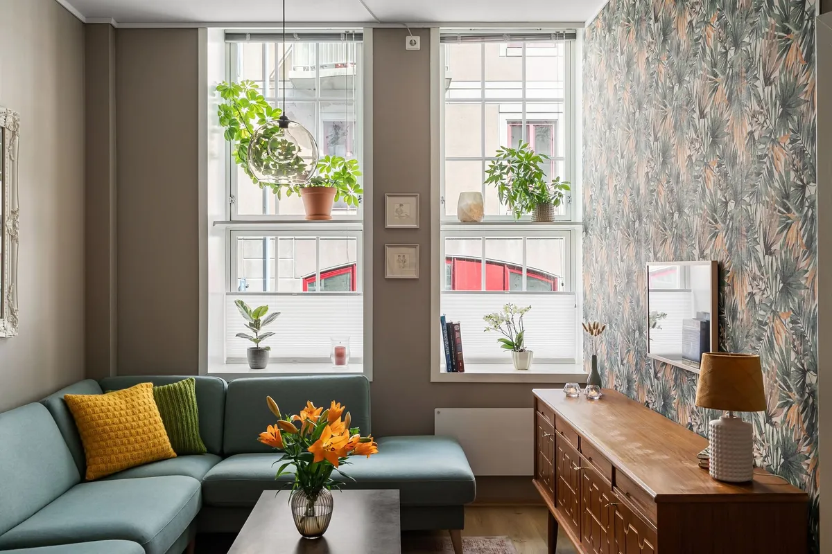 Bright summer living room with linen textiles and tropical plant accents