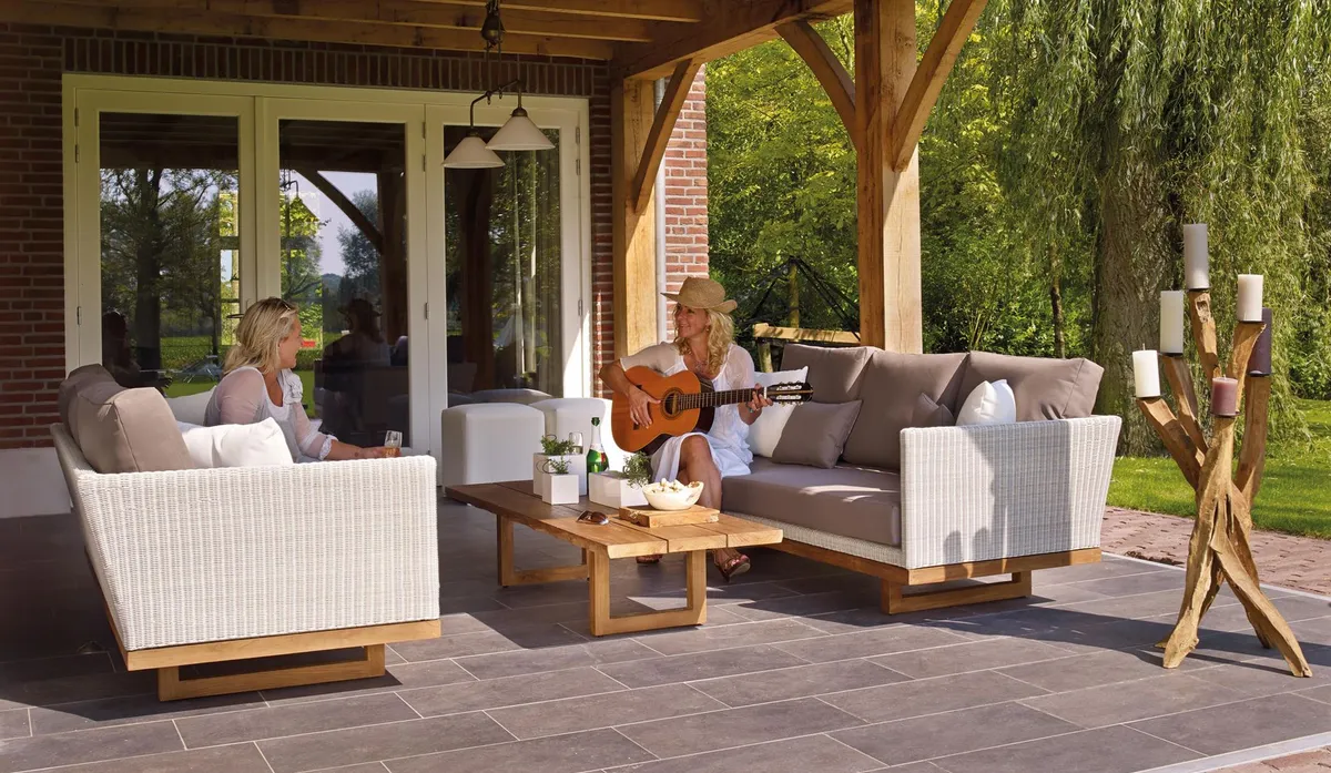 Outdoor dining area with weather-resistant furniture and string lights