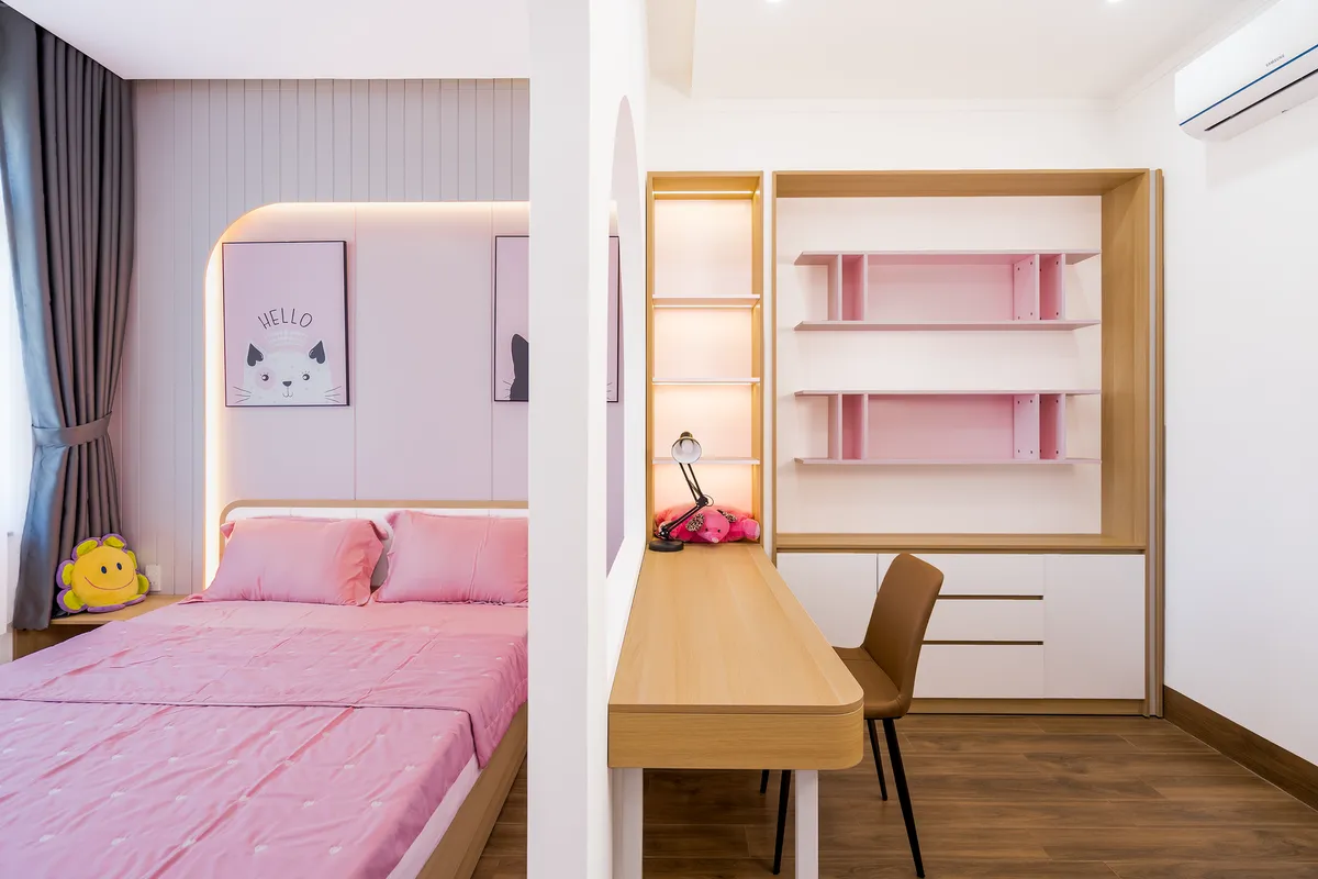 Teen bedroom with dedicated study desk, functional lighting, and personal expression wall