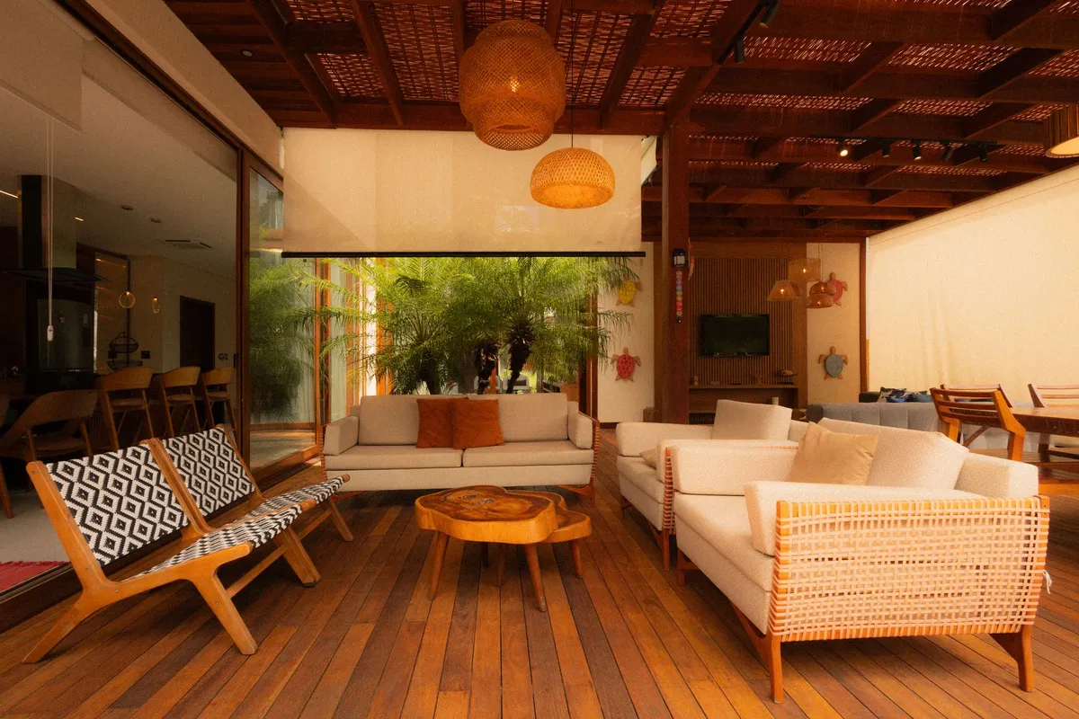 Natural rattan furniture and tropical plants in a bright indoor living space