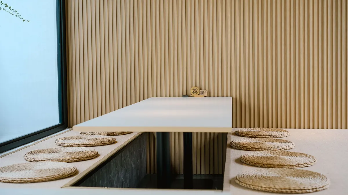 Wabi-sabi interior with weathered wood surfaces, handmade ceramics, and quiet natural material palette