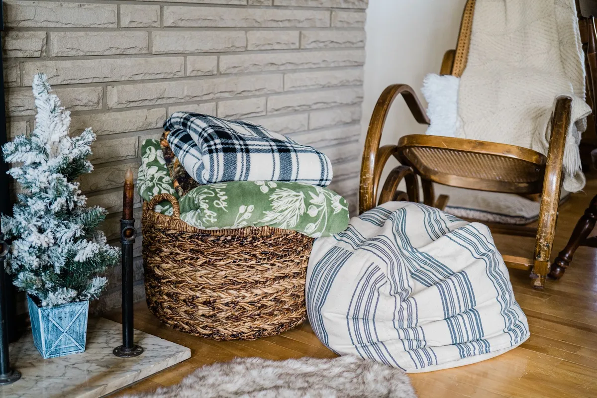 Winter bedroom with layered quilts, velvet pillows and warm candle light